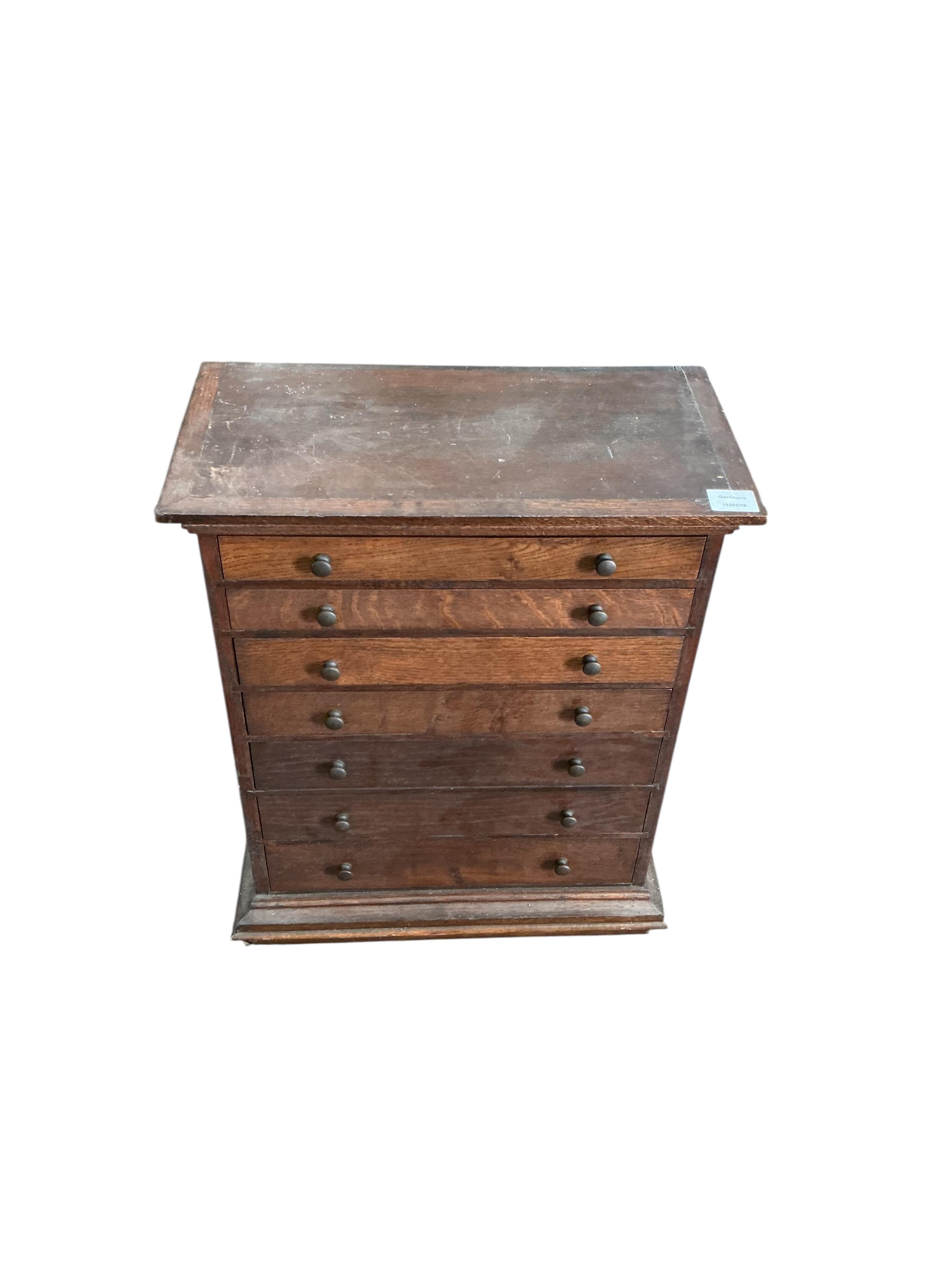 An early 20th century oak seven drawer collectors chest, width 51cm, depth 27cm, height 63cm